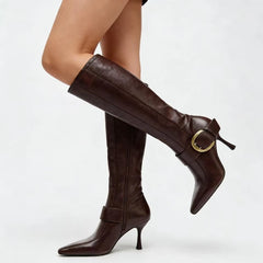 Model wearing pointed toe stiletto heel knee high boots.