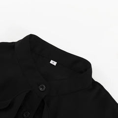 Close-up of a black shirt collar with a button on a white background