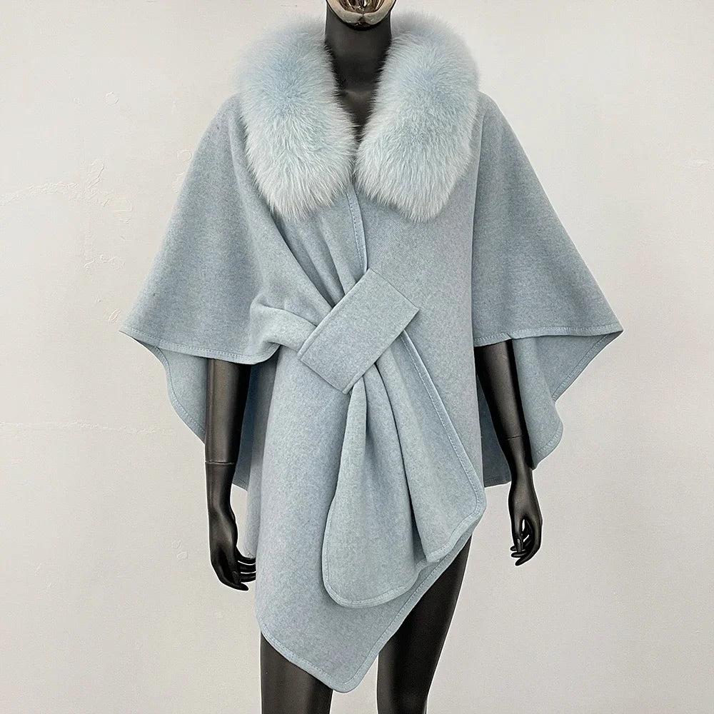 Light blue knit poncho with a soft blue fur collar and knotted front.