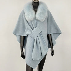 Light blue knit poncho with a soft blue fur collar and knotted front.