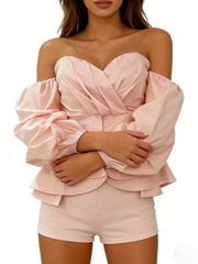 Pink off-shoulder top and shorts set on a white background