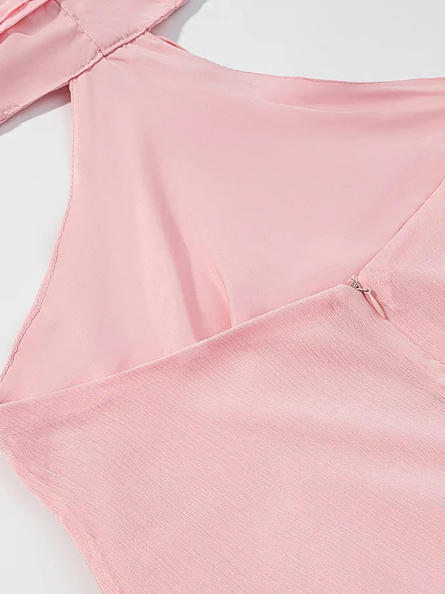 Close-up of a pink garment with a zipper on a white background