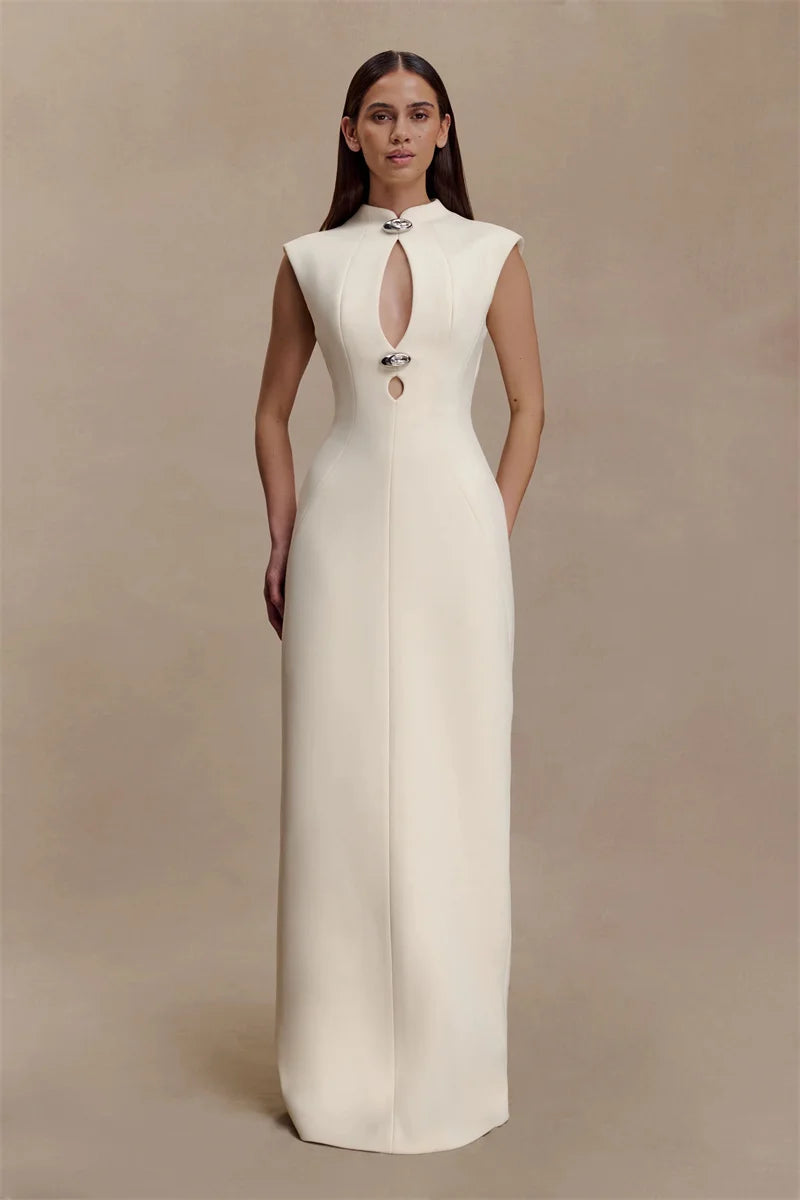 Woman wearing a white evening gown against a beige background