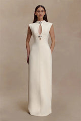 Woman wearing a white evening gown against a beige background