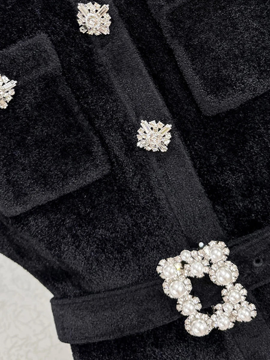 Black coat with decorative buttons featuring floral designs.