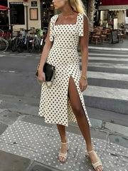 Full body view of a square neck polka dot midi dress with tie shoulder straps