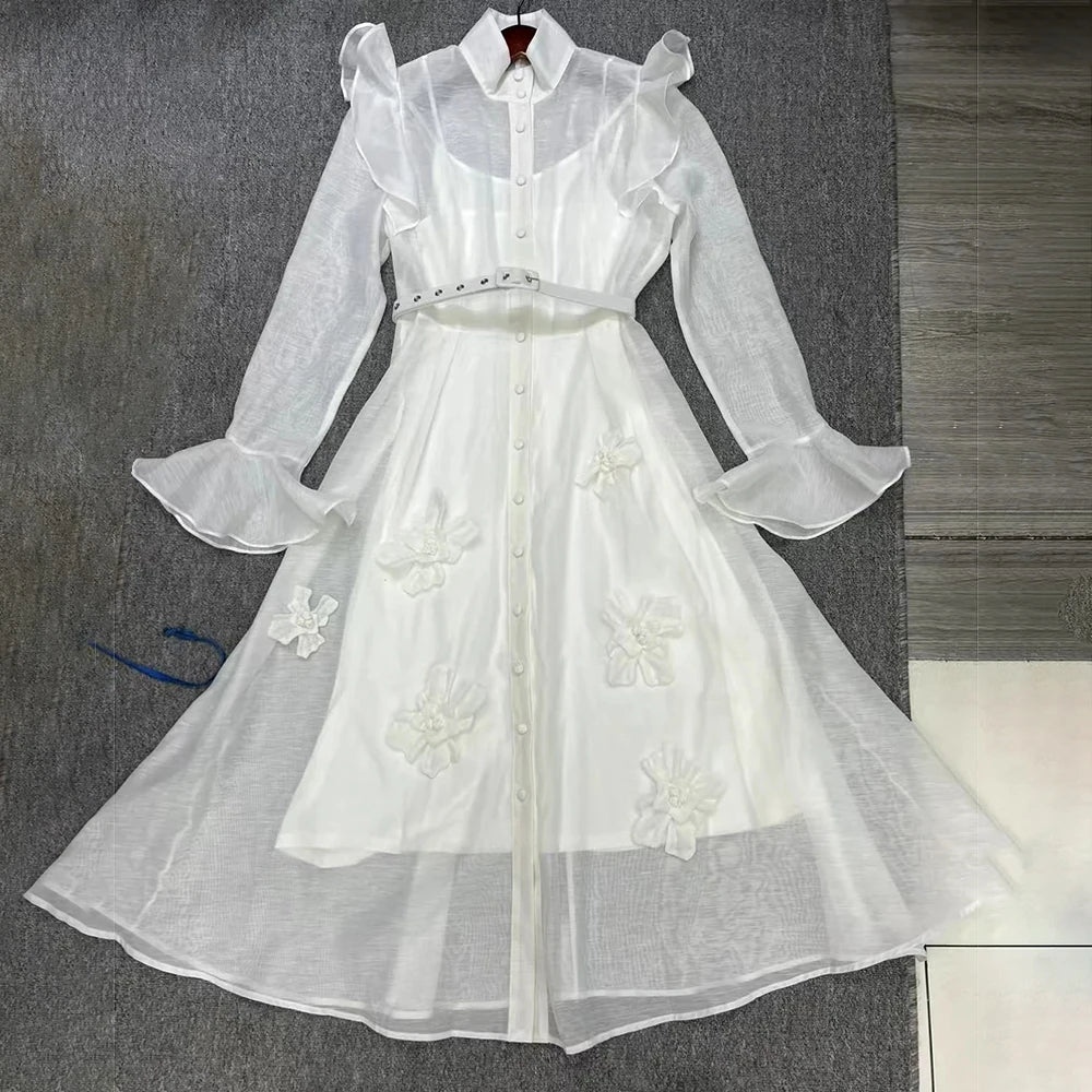 White floral dress on a gray surface