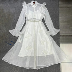 White floral dress on a gray surface