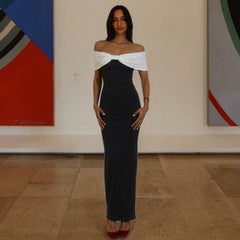 Woman in a black and white dress standing in an art gallery.