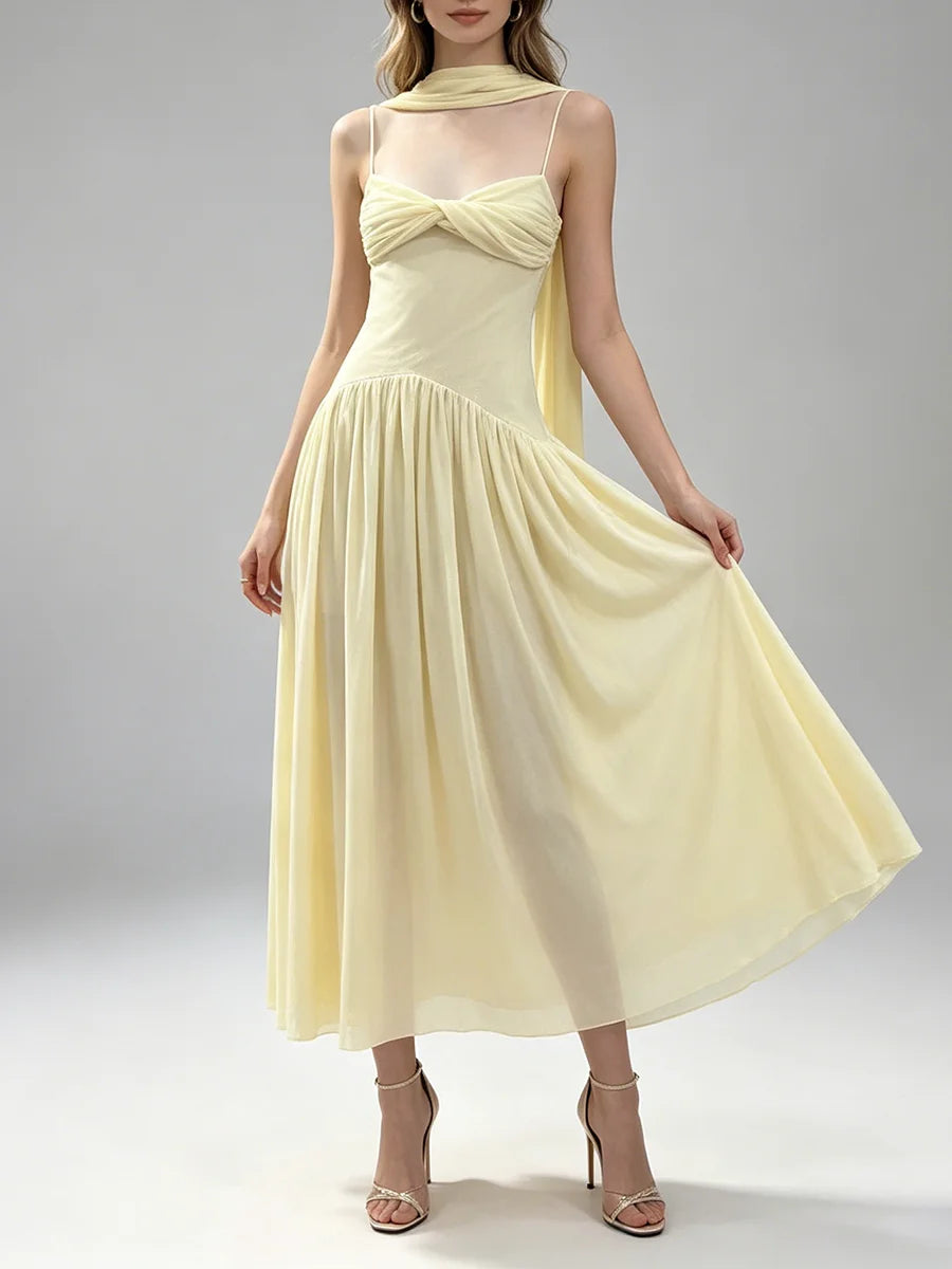 Model wearing a pale yellow ruched twist front midi dress