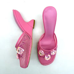 Pink mesh wedge mules with floral embellishments