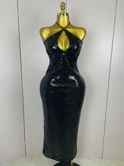 Black sequin dress on a mannequin against a white background