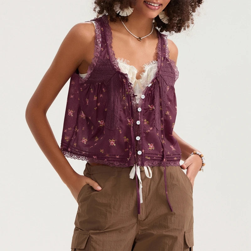 Woman wearing a purple sleeveless top with lace details and brown pants on a white background