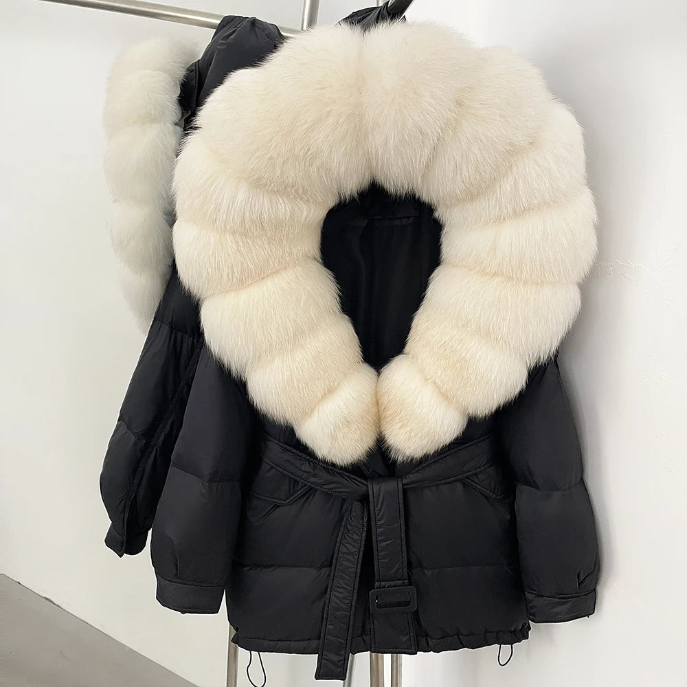 Black puffer jacket with a large white fur collar