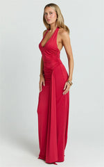 Woman wearing a red halter neck gown on a white background