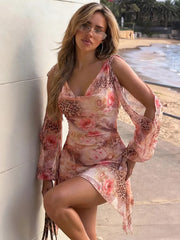 Ruched v-neck animal floral print mini dress leaning against wall