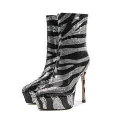Black and silver striped high-heeled platform boots on a white background
