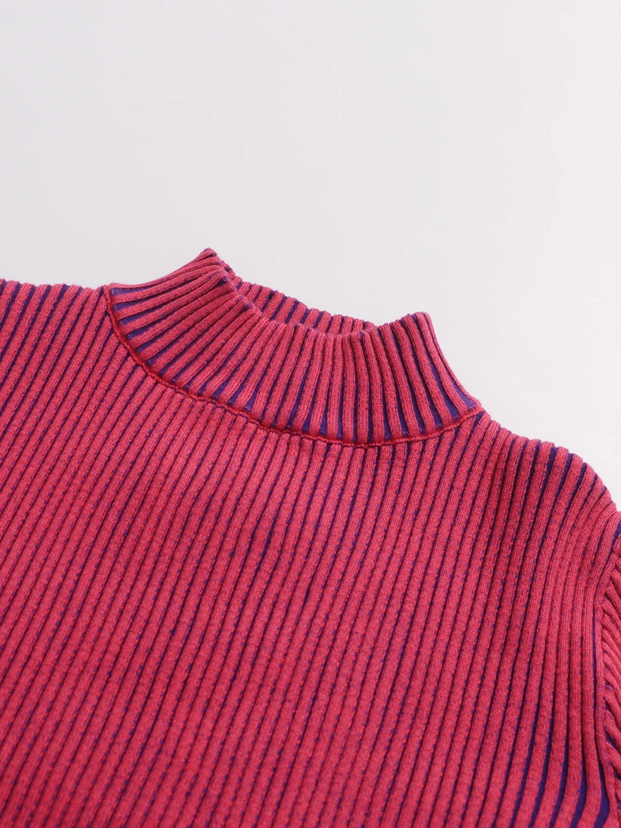 Close-up of a red ribbed top collar on a light grey background