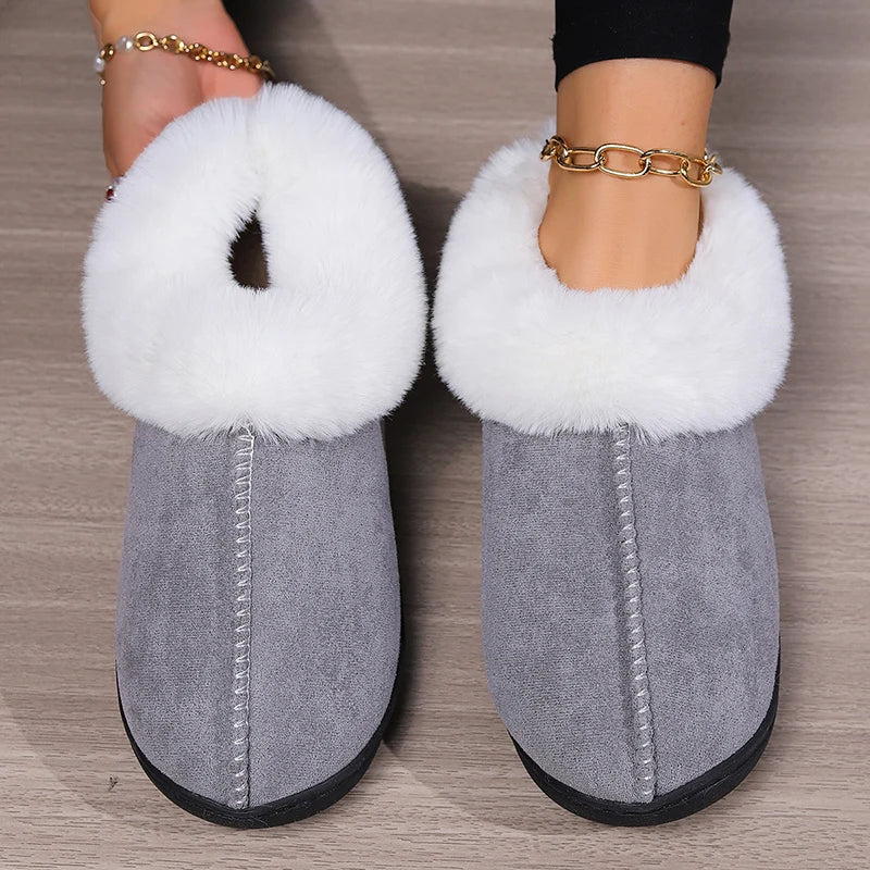 Gray slippers with white fur trim worn on a wooden floor