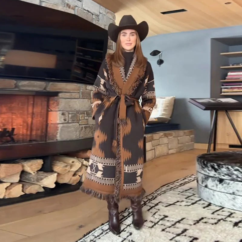 Person wearing a patterned robe and cowboy hat in a cozy living room with a fireplace.