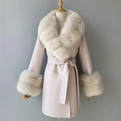 Pink coat with fur trim on a mannequin against a gray background