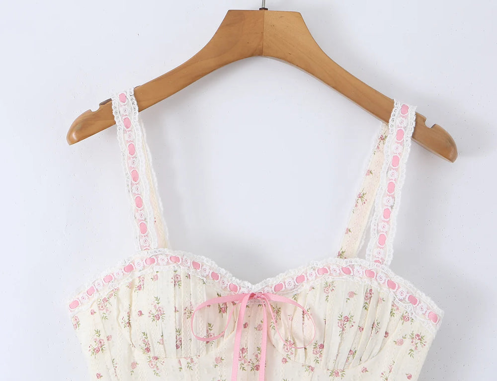 Close-up of lace trim and ribbon bow on floral print corset crop top.