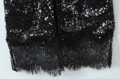 Close-up of lace trim and sequin detail on maxi dress hem