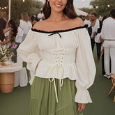Woman wearing off-shoulder white corset blouse with lace-up front
