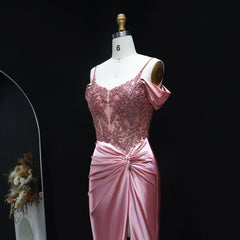 Pink evening gown on a mannequin against a black background