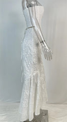 Mannequin wearing a silver sequin dress against a plain background
