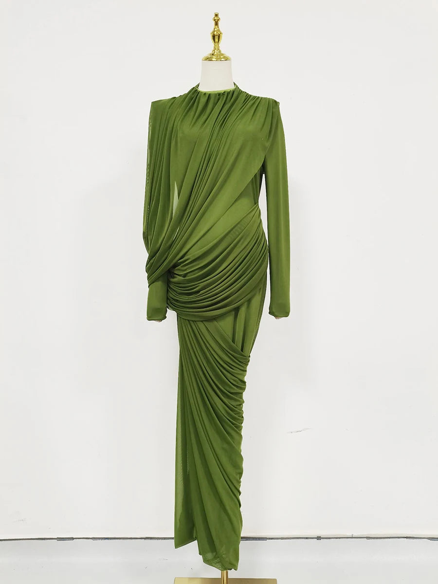 Green draped dress on a mannequin against a white background