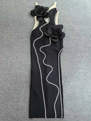 Black dress with floral straps on a gray background