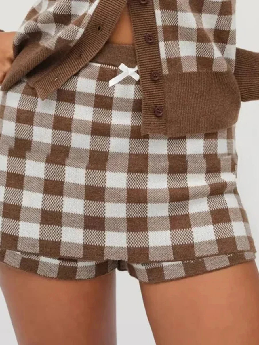 Brown and white checkered outfit with a cardigan on a plain background