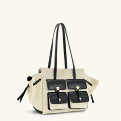 Beige handbag with black accents on a white background