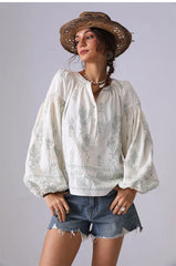 V-neck embroidered cotton blouse with green floral details and lantern sleeves