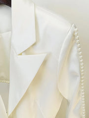 Close-up of a white fabric with pearl trim