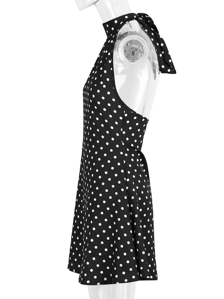 Black polka dot dress on a mannequin against a white background