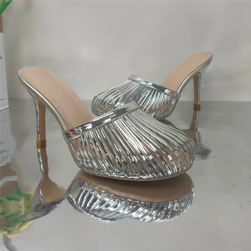 Silver metallic stiletto mule heel with open toe and caged design
