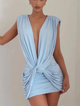 Light blue dress with a deep neckline and side knot on a plain background