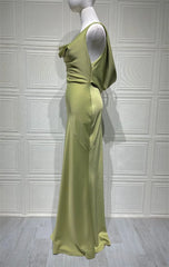 Mannequin wearing a light green evening gown against a white paneled wall.
