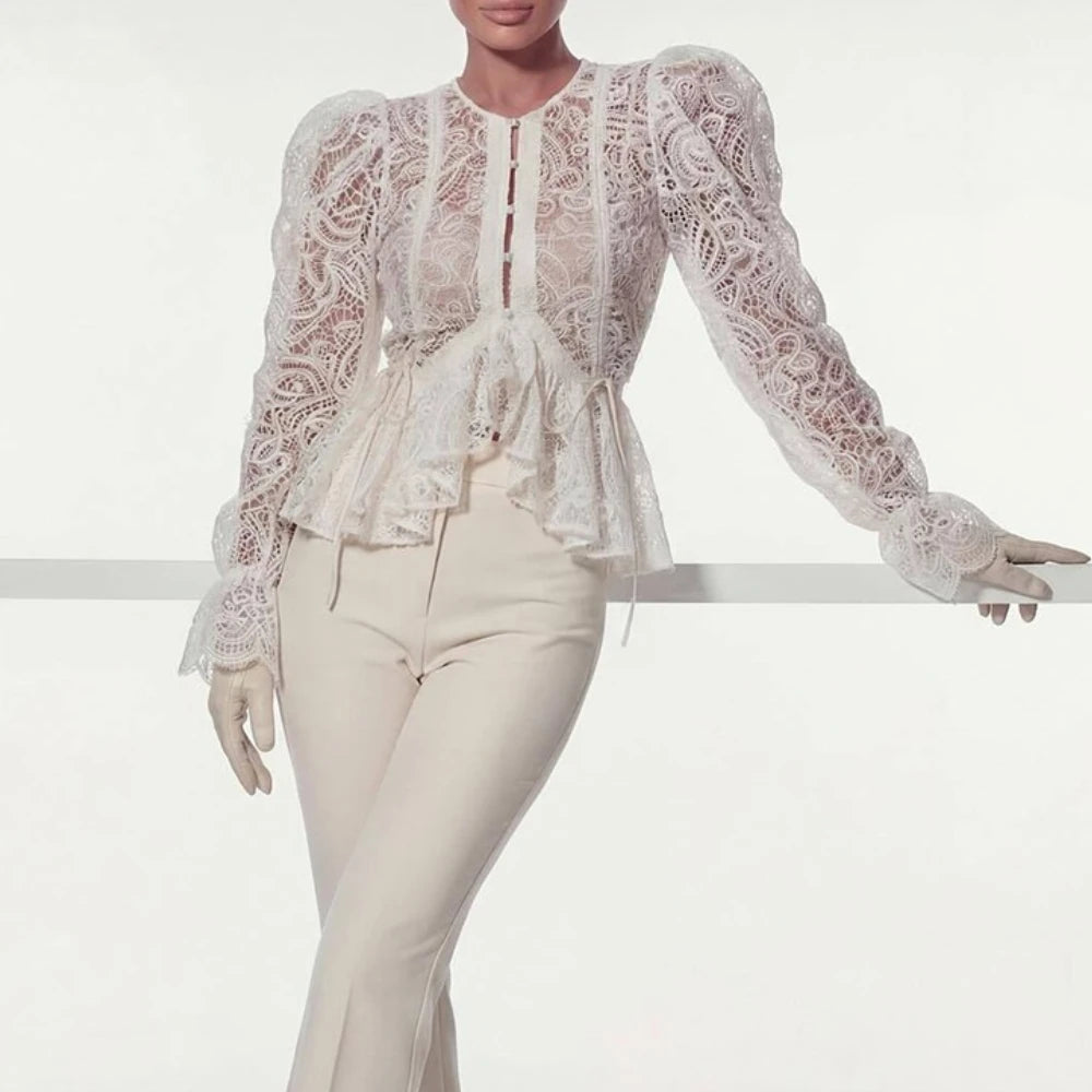 White puff sleeve lace peplum blouse leaning on railing.