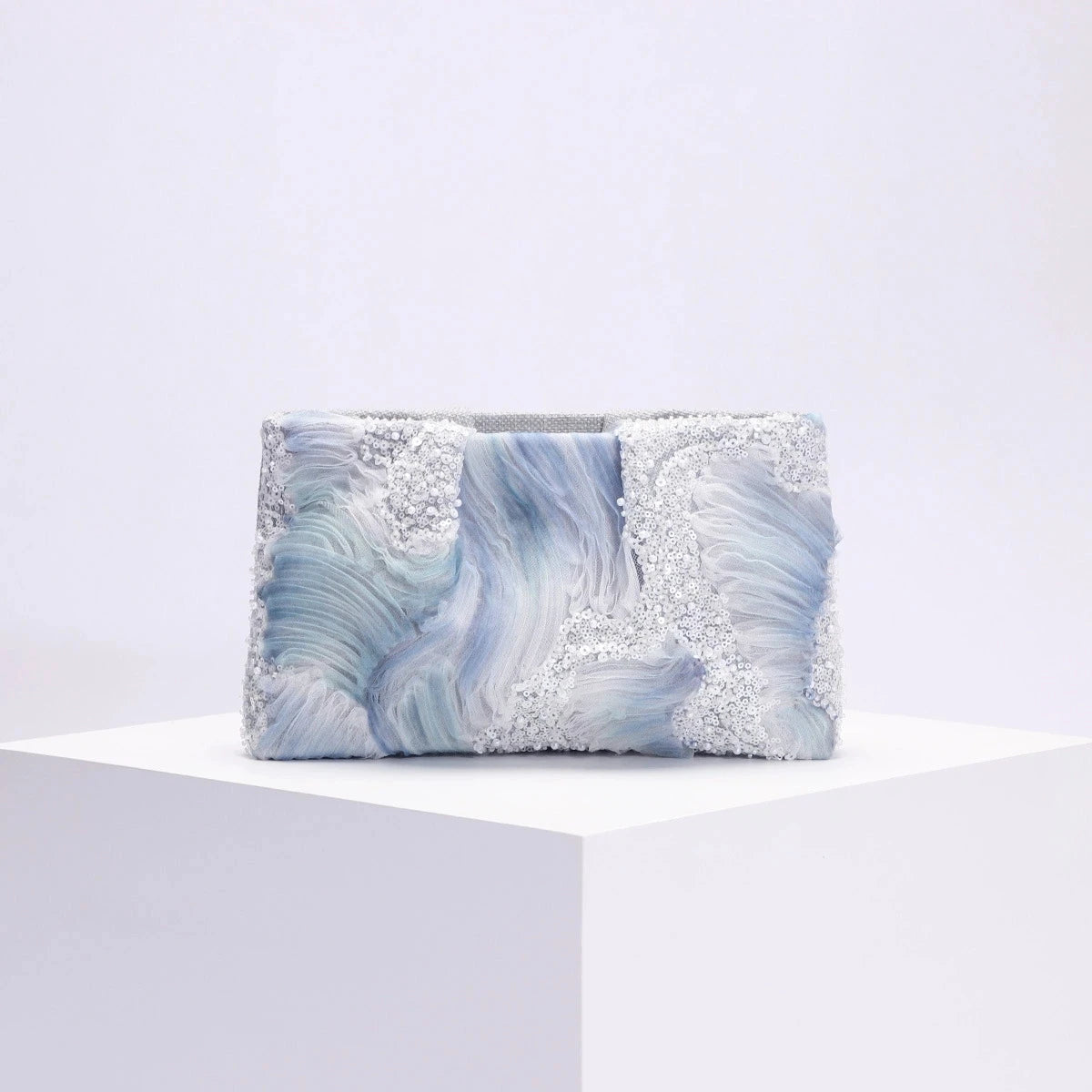 Clutch bag with blue and gray marbled pattern on a white background