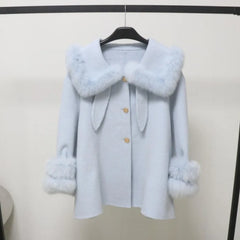 Light blue coat with fur trim on a hanger against a white background