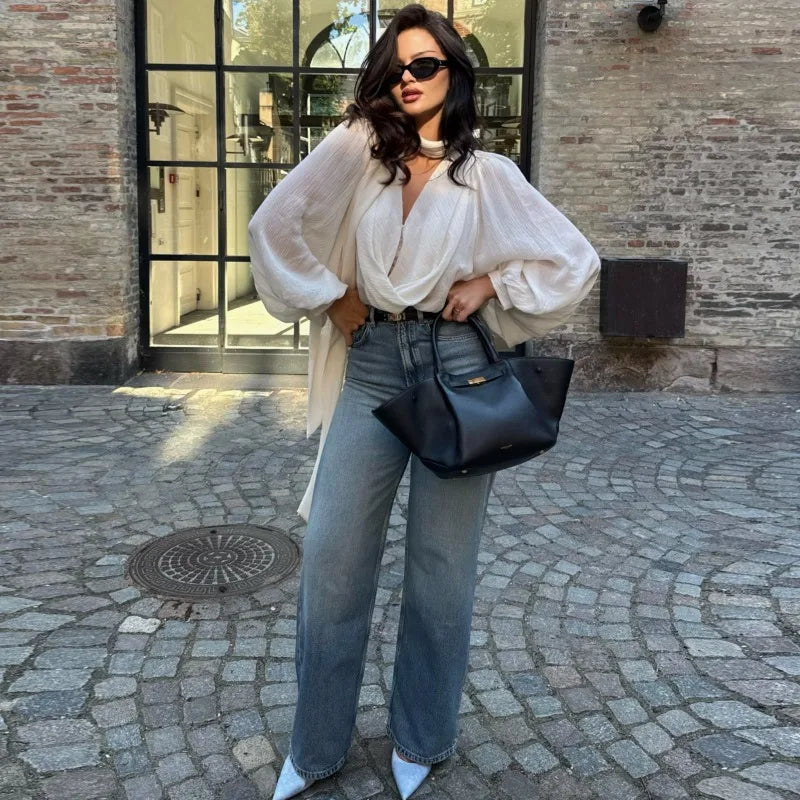 Draped V-neck long sleeve top styled with wide-leg jeans