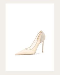 Beige high-heeled shoe with glittery details on a white background