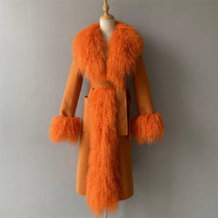 Orange coat with fur trim on a mannequin against a plain background