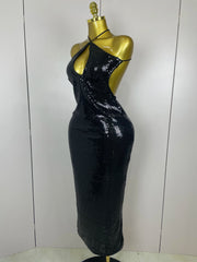 Black sequin dress on a mannequin against a white background