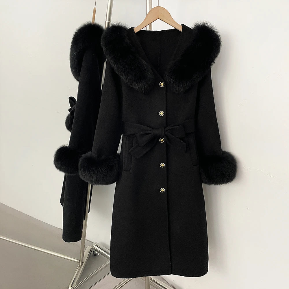 Black wool coat with fox fur collar and cuffs, belted.