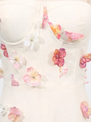 White top with colorful floral embellishments on a white background