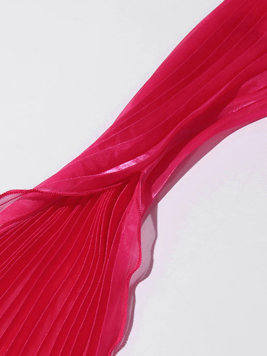 Close-up of a red pleated fabric on a light gray background